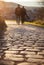 Couple walking on cobblestone foot path