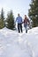 Couple Walking Down Snow Covered Hill