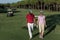 Couple walking on golf course