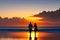 A couple walking hand in hand along a beach at sunset. Generative AI