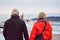 Couple walking on a long pier, on a cold winter day.