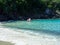 A couple walking out onto a Beautiful  beach on a bright sunny day