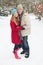 Couple Walking Through Snowy Woodland