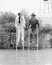 Couple walking on stilts