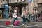 Couple walking in the street with suitcase in front of the train station