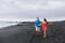 Couple walking travel holidays black sand beach