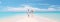 couple walking on a tropical white sandy beach