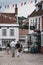 Couple walking under the colourful bunting on a street in Lymington, New Forest, UK