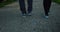 Couple walking with white shoes in the park in San Martino di Castrozza, Italy