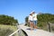 Couple walking on a wooden pontoon admiring nature