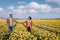 Couple walking in yellow flower bed , men and woman in yellow daffodil flowers during Spring in the Netherlands Lisse