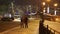 Couple walks through the city at night in winter