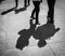 Couple walks by the paved italian street contrast shadow image