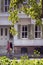 Couple walks by a white, wooden, historical house