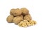 Couple of walnut kernels in front of pile of walnut shells on white background. Healthy and tasty snacks.