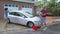 Couple washing car in driveway