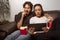 Couple watches movie on tablet. They so sitting on the sofa at h