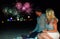 Couple watching colorful fireworks at the beach