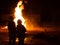 Couple watching a large bonfire at night