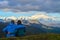 Couple watching a morning view of Mount Denali - mt Mckinley peak during golden hour from Stony Dome overlook. Denali