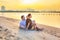 Couple watching romantic sunrise on the beach