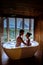 Couple watching sunset in bathtub in the bathroom during vacation in Thailand watching sunset over the ocean and