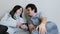 Couple watching TV lying on the couch. Man and a woman look at each other and smile.