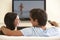 Couple Watching Widescreen TV At Home