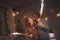 Couple waving with sparklers for New Year midnight countdown