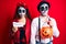 Couple wearing day of the dead costume holding pumpking and halloween paper depressed and worry for distress, crying angry and