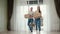 Couple wearing jeans enters new house glass panoramic door