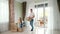 Couple wearing jeans enters new house glass panoramic door