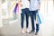 Couple Wearing Jeans While Holding Paperbags In Shopping Mall