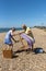 Couple wearing masks open a deckchair during Covid-19 outbreak