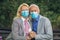 Couple wearing protective face masks outdoors