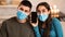 Couple wearing surgical mask using smart phone