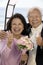 Couple at wedding giving thumbs-up smiling (portrait)