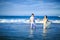 Couple in wet clothing goes in water at beach