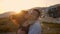 Couple whirls on the beach in the sunset