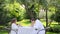 Couple in the white bathrobes have breakfast in the garden