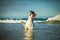 Couple in white clothes in water on beach