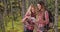 Couple of white female hikers checking map while exploring in forest setting