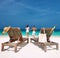 Couple in white running on a beach at Maldives