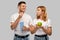 Couple in white t-shirts with popcorn and apple