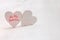 Couple of white wooden hearts. Glitter overlay