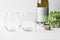 Couple wine glass mockup with bottle opener, cork, greenery and wine bottle.