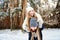 Couple in winterwear at the winter forest