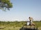 Couple With Woman Looking Through Binoculars In Jeep