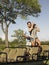 Couple With Woman Looking Through Binoculars In Jeep