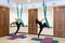 Couple womans doing fly yoga stretching exercises in gym. Fit and wellness lifestyle